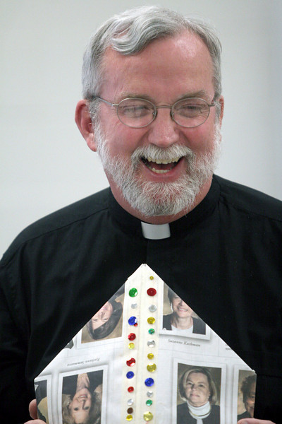 standrew-milford > Father Rob Waller smiles with his pope hat  with the students at the Seton campus of St. Andrew-St. Elizabeth Ann Seton School in Milford  celebrated the Pope Benedict's visit to the US and his 81st birthday . (Photo by Tony Tribble)